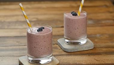 two smoothies in glasses with striped straws