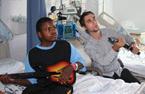 a patient and volunteer play with an air guitar